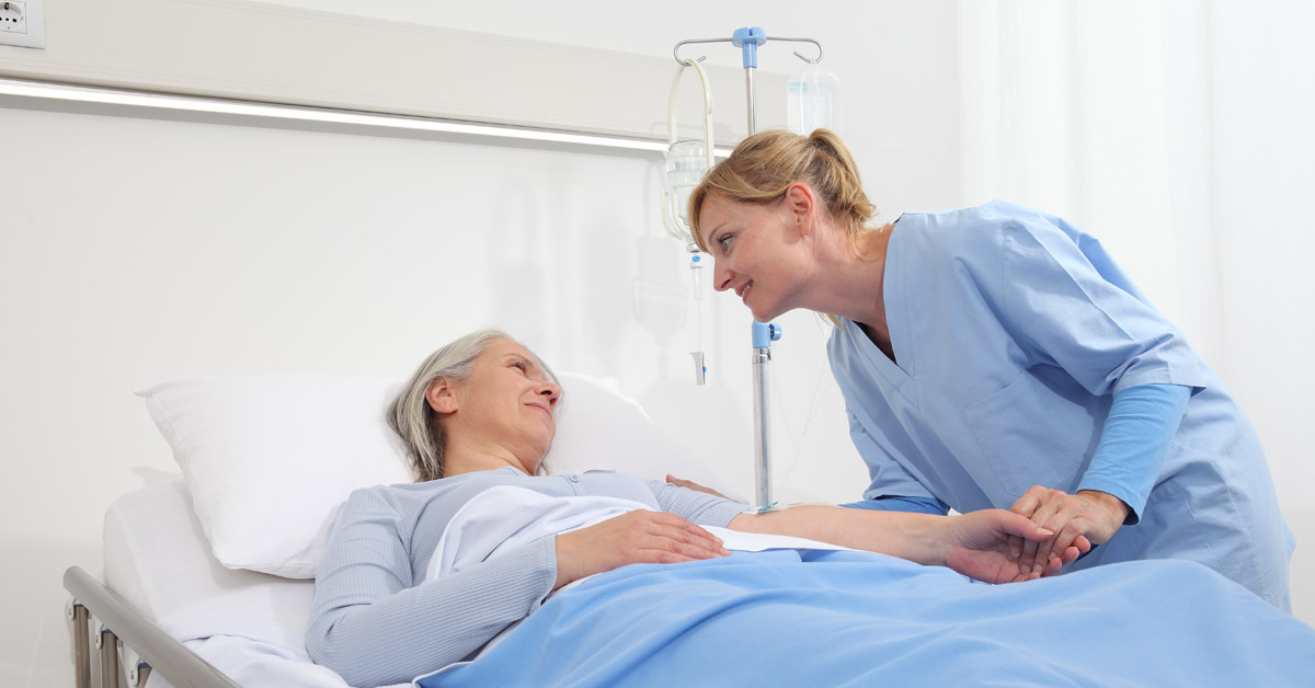 Nurse Comforting A Hospice Patient.