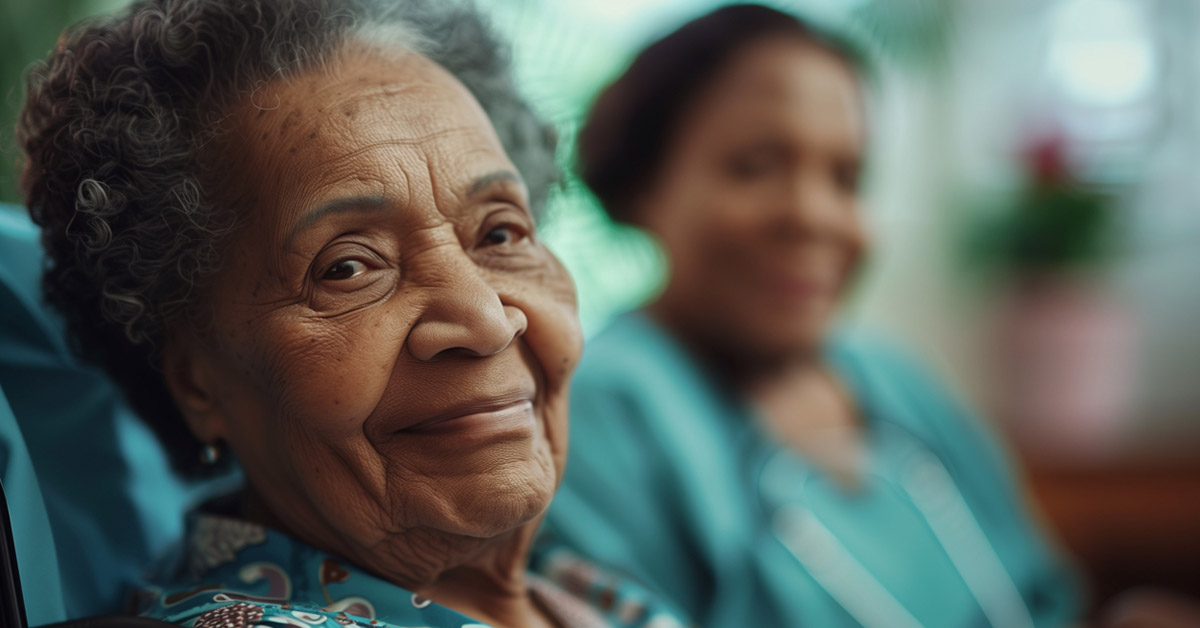 African American Elderly Lady Sitting With Her Hospice Nurse